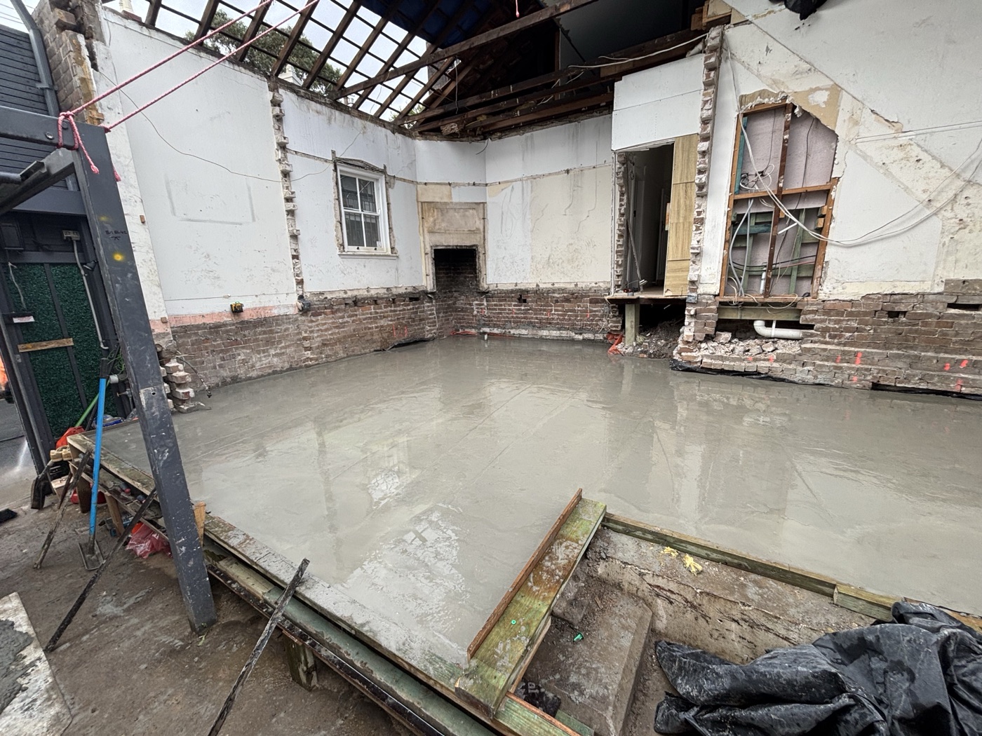 Concrete slab poured within an existing brick shell