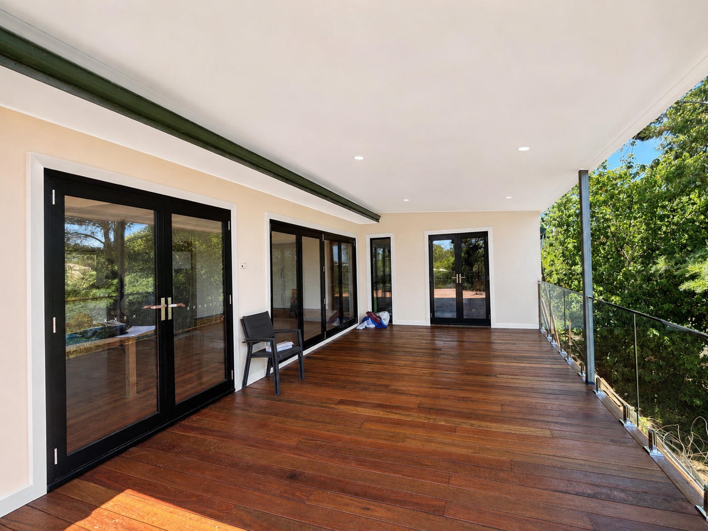 Upper-level deck with black bifold doors