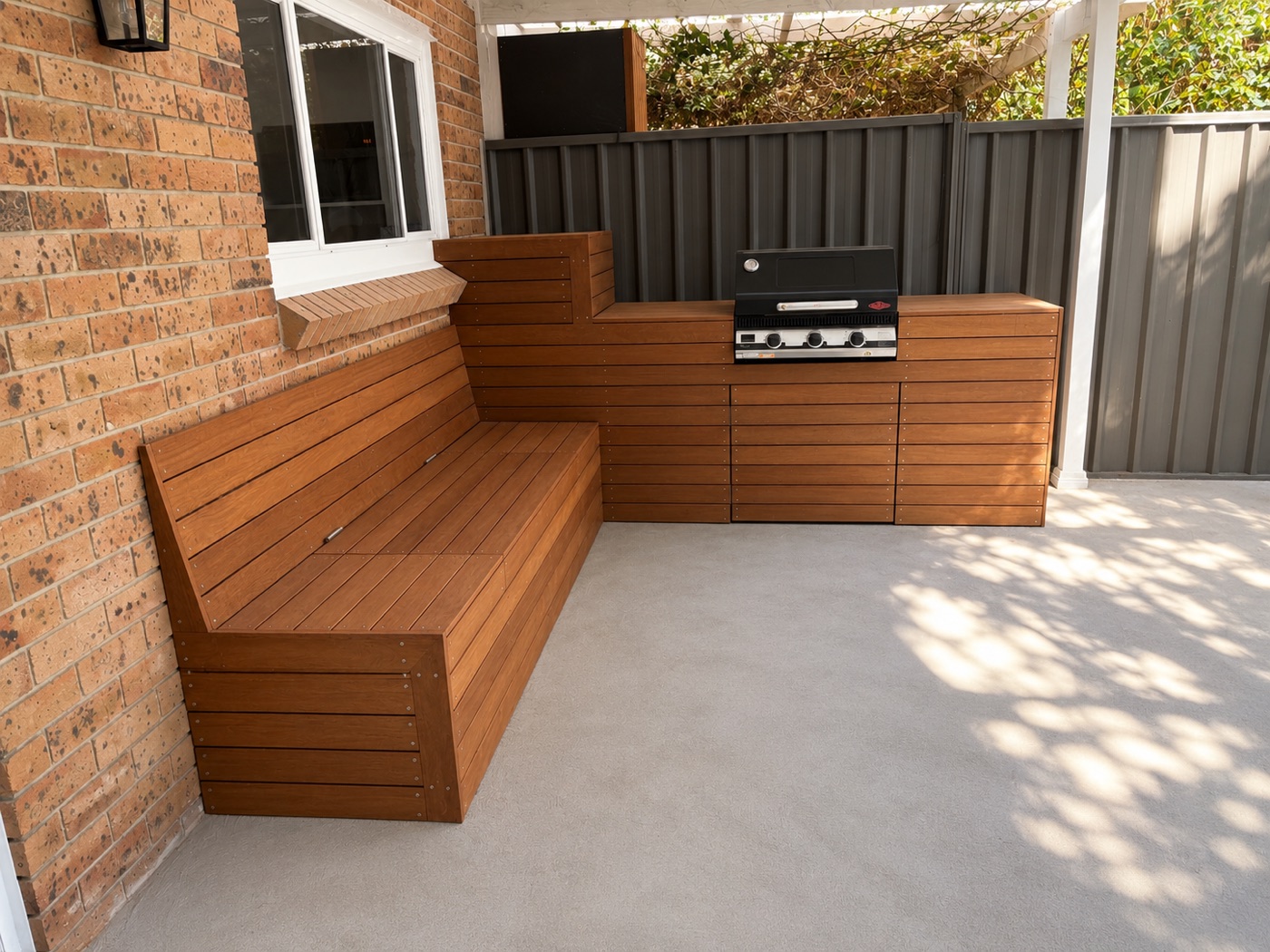 Built-in composite outdoor kitchen and bench seating