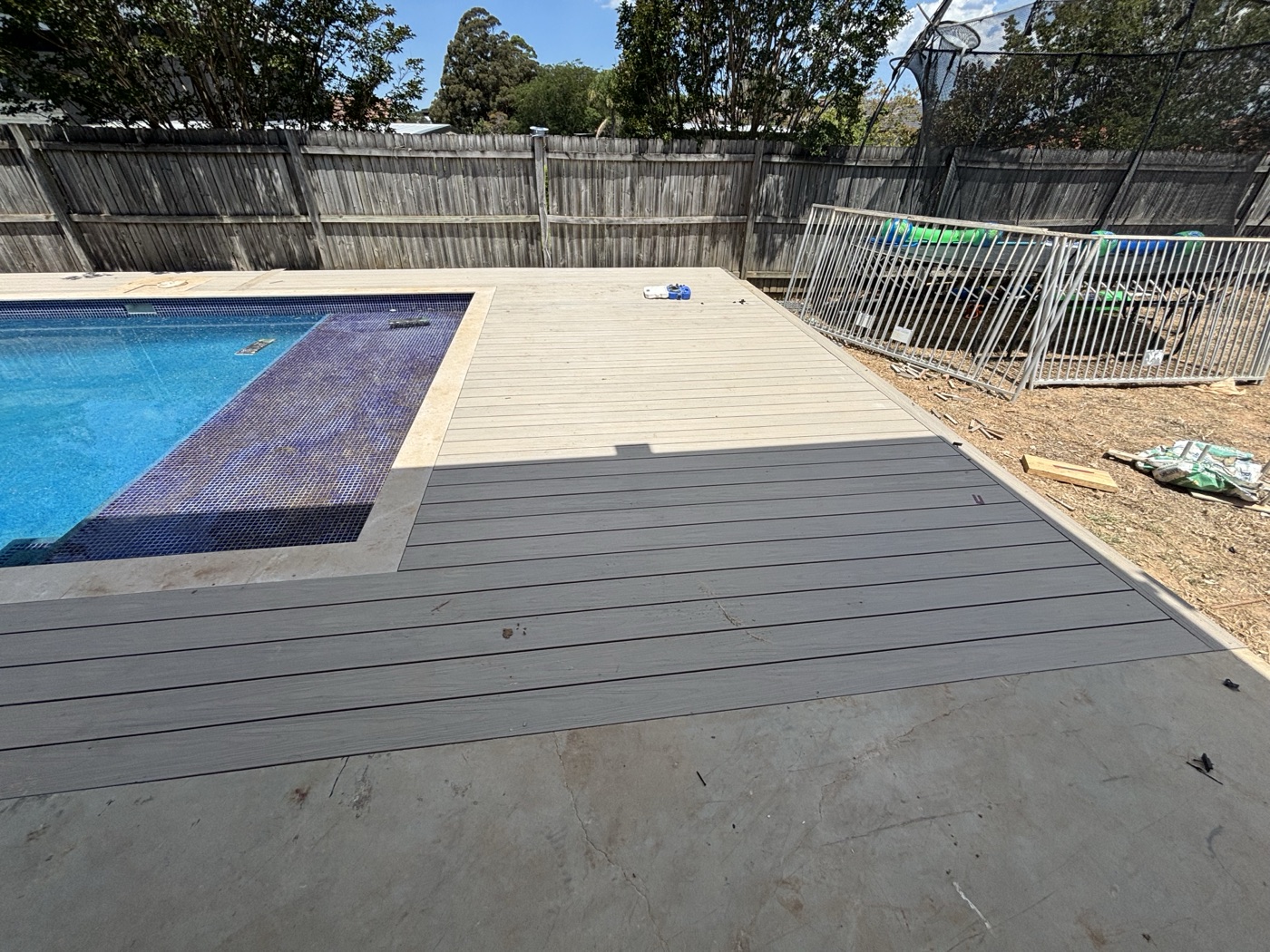 Two-tone composite deck around a pool