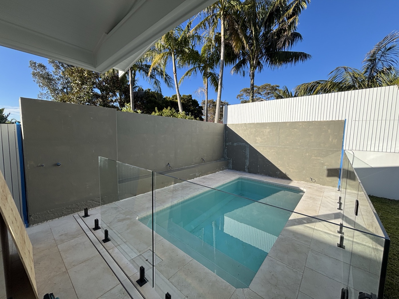 Pool area with glass fencing and covered alfresco